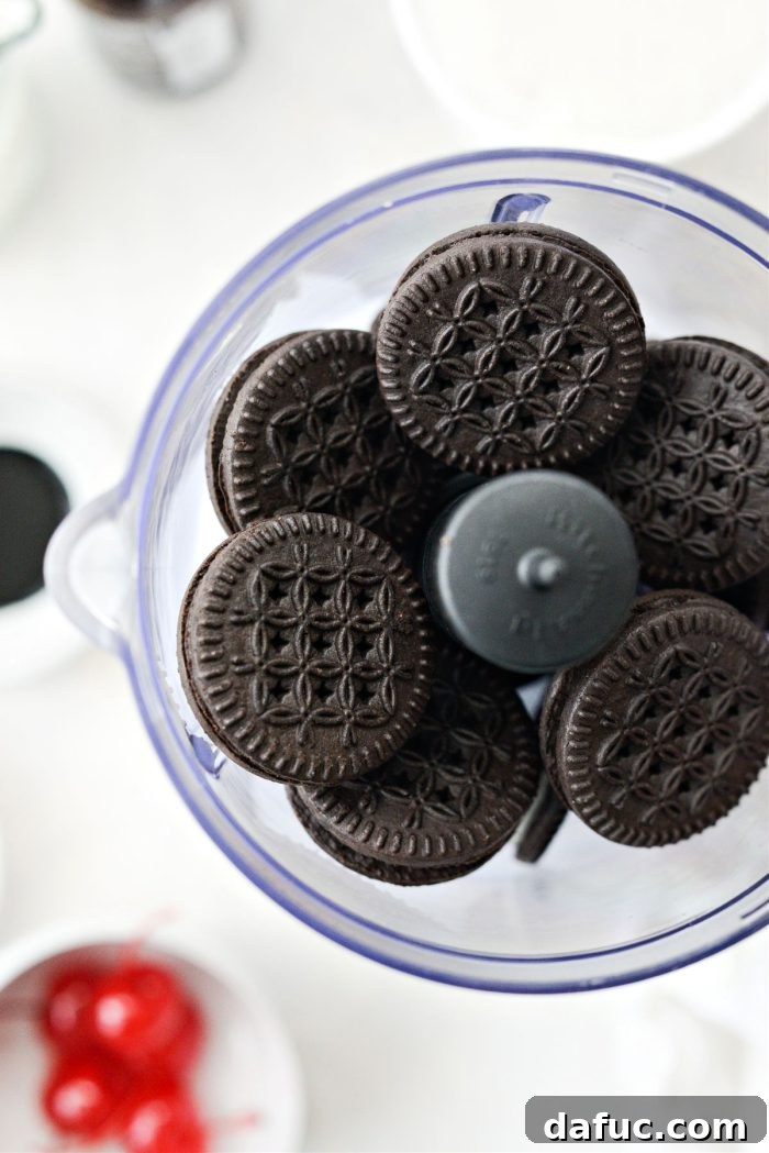 Chocolate sandwich cookies being crushed in a mini food processor