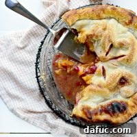 Freshly baked Peach Raspberry Pie with a scoop of vanilla ice cream