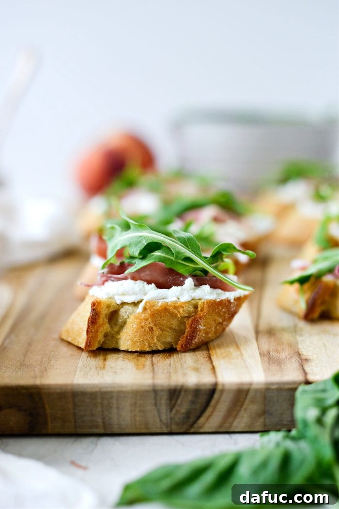Peach Prosciutto Chèvre Crostini 11 Layering fresh baby arugula leaves on top of prosciutto and goat cheese crostini