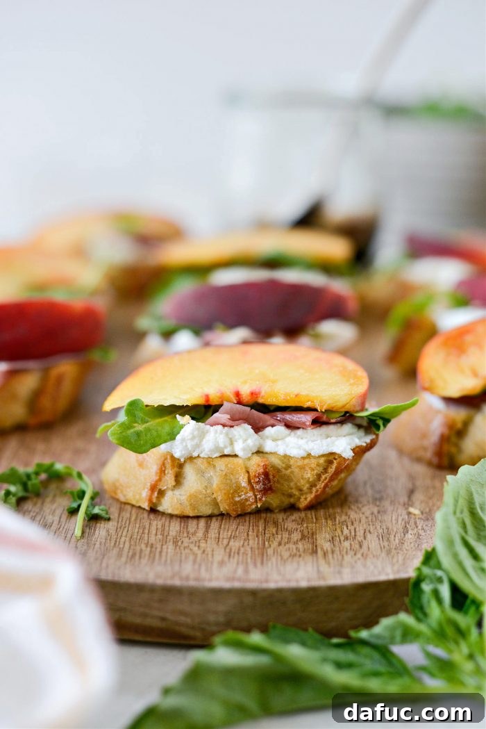 Peach Prosciutto Chèvre Crostini 12 Placing a juicy peach slice on top of the arugula, prosciutto, and goat cheese crostini