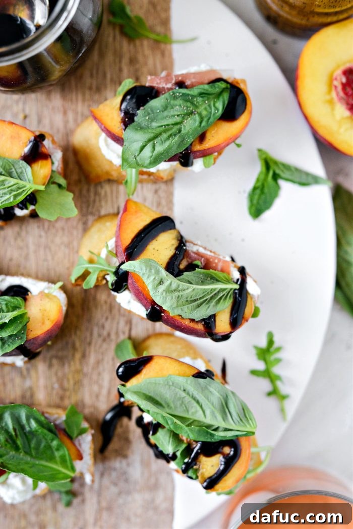Peach Prosciutto Chèvre Crostini 3 Close-up of freshly assembled Peach Prosciutto Goat Cheese Crostini with arugula and basil