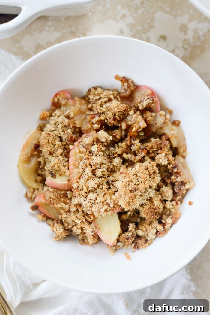 Effortless Apple Crumble 13 Easy apple crisp served in a white bowl, ready to be enjoyed.