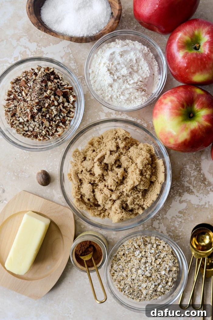 Effortless Apple Crumble 4 Ingredients for Easy Apple Crisp laid out: apples, oats, sugar, salt, flour, butter, cinnamon, nutmeg, and pecans.