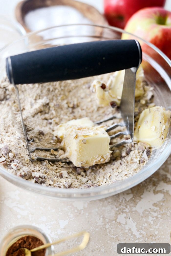Effortless Apple Crumble 8 Cutting softened butter into the dry topping ingredients with a pastry blender.