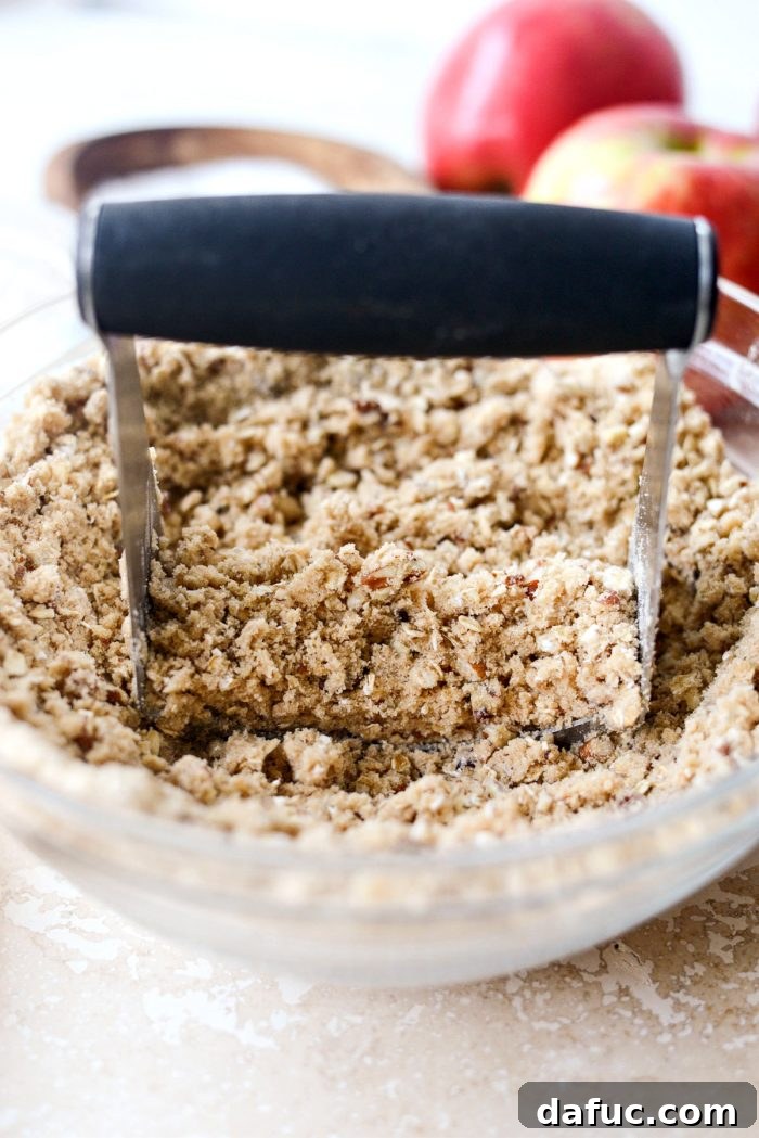 Effortless Apple Crumble 9 The final crumbly oat topping mixture in a glass bowl, ready for assembly.