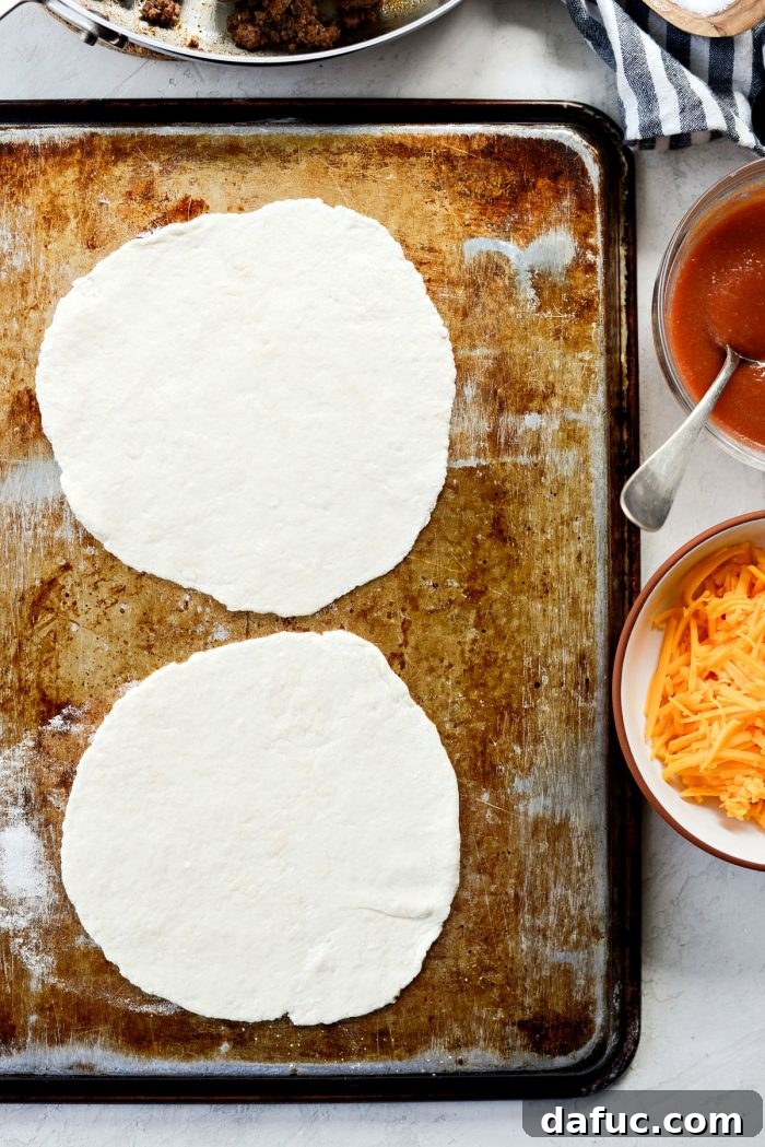 Placing rolled out dough discs onto an inverted baking sheet