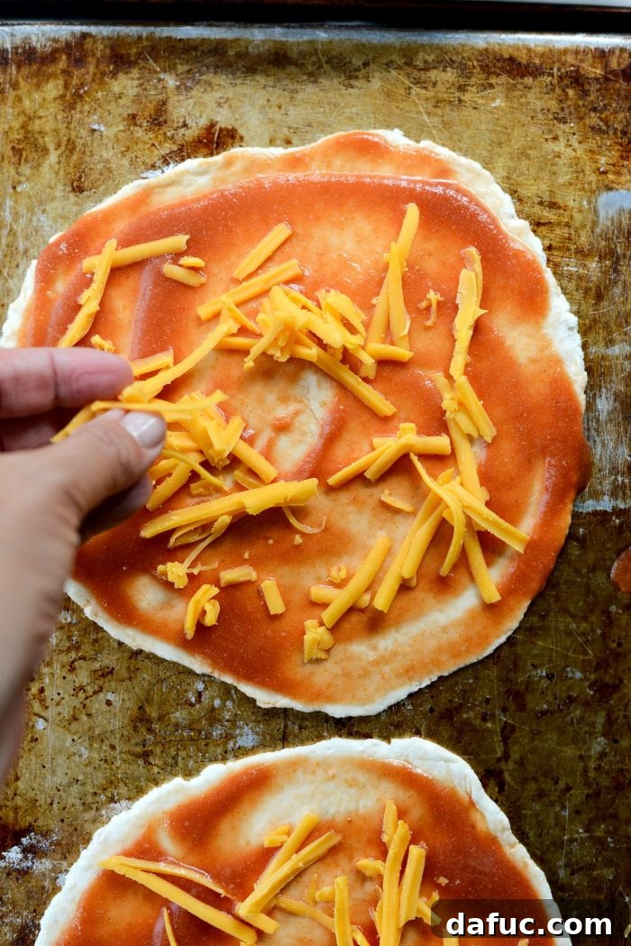 Sprinkling cheese on the Fiestada sauce layer