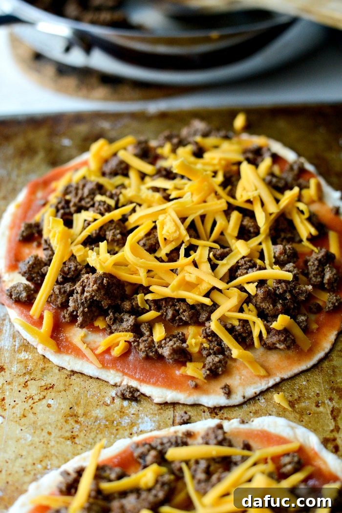 Layering taco meat and more cheese on Fiestadas