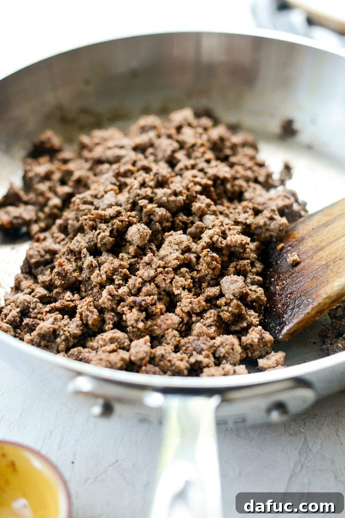Adding taco seasoning to cooked ground beef for Fiestadas