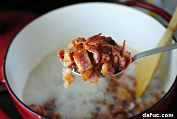 Removing cooked bacon with a slotted spoon