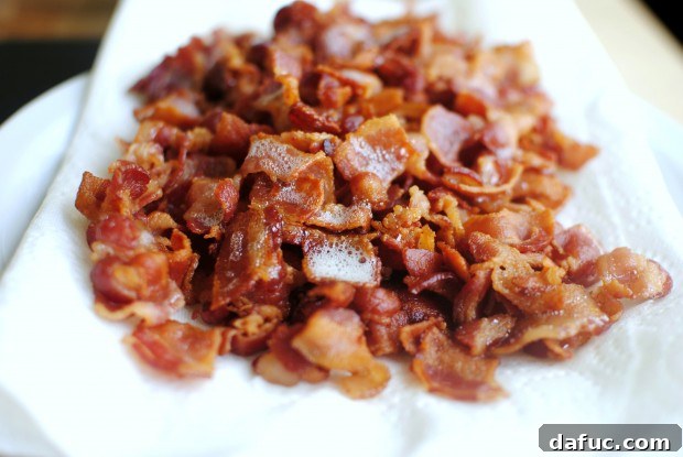 Cooked bacon on a paper towel lined plate