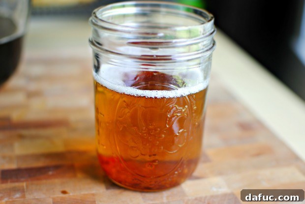 Spoon bacon grease into a jar