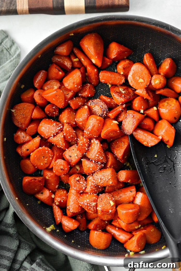 Finishing the maple glazed carrots with a final sprinkle of salt and freshly ground black pepper