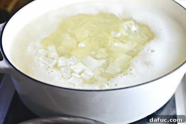 Potatoes and onions simmering in a pot