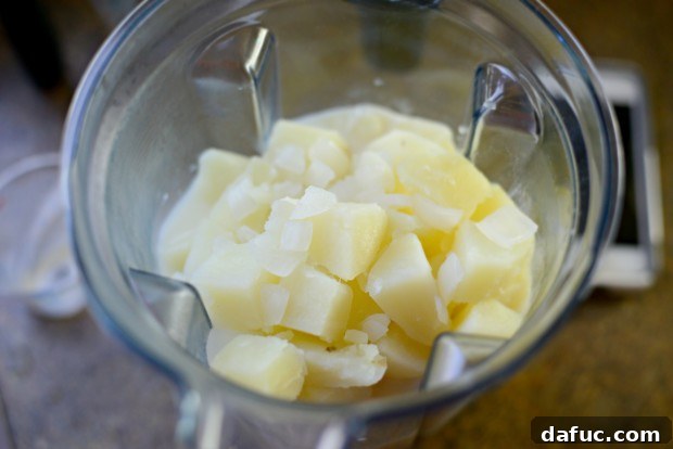 Drained potatoes and onions in a colander