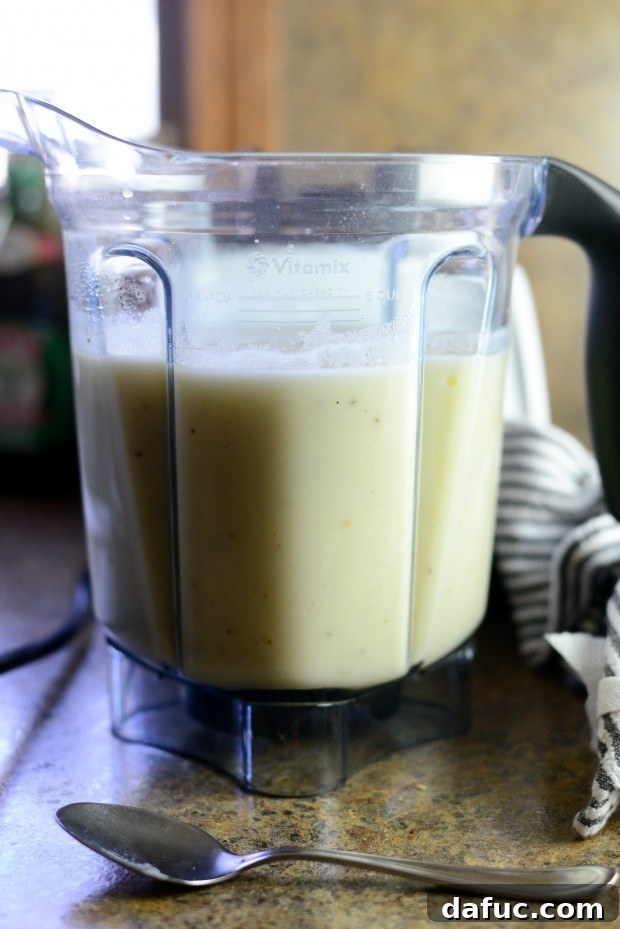 Smooth and creamy roasted garlic potato soup in a blender