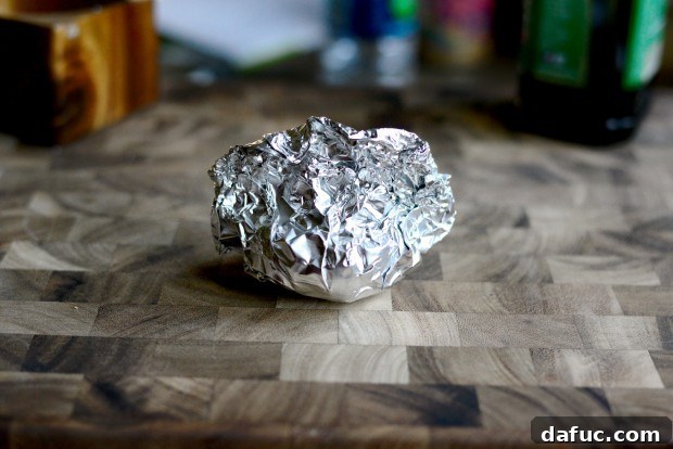 Garlic wrapped in aluminum foil with olive oil and salt