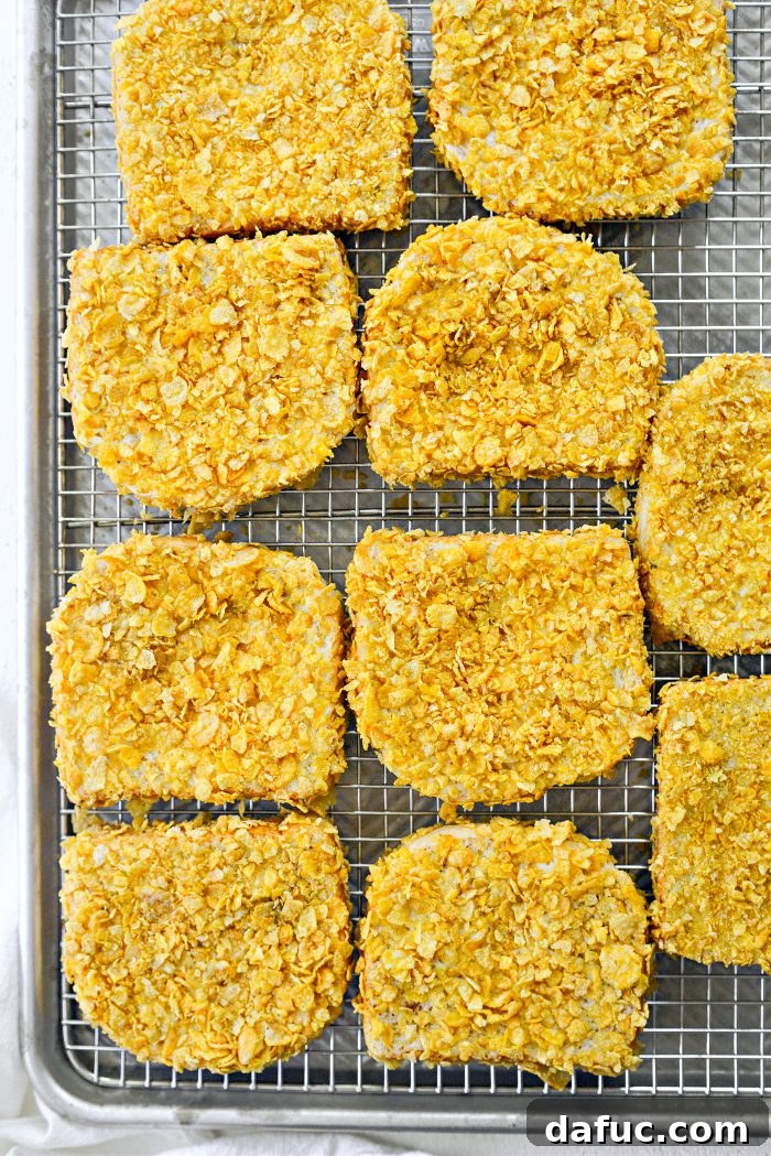 Crunchy Cornflake French Toast 11 Transferring coated French toast to a wire rack on a rimmed sheet pan