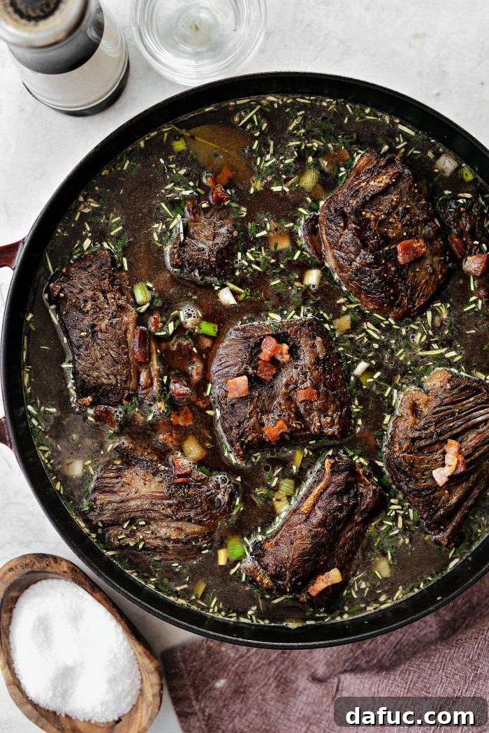 Slow-Braised Beef Short Ribs 15 Seared short ribs and crispy bacon pieces nestled back into the rich braising liquid in the Dutch oven.