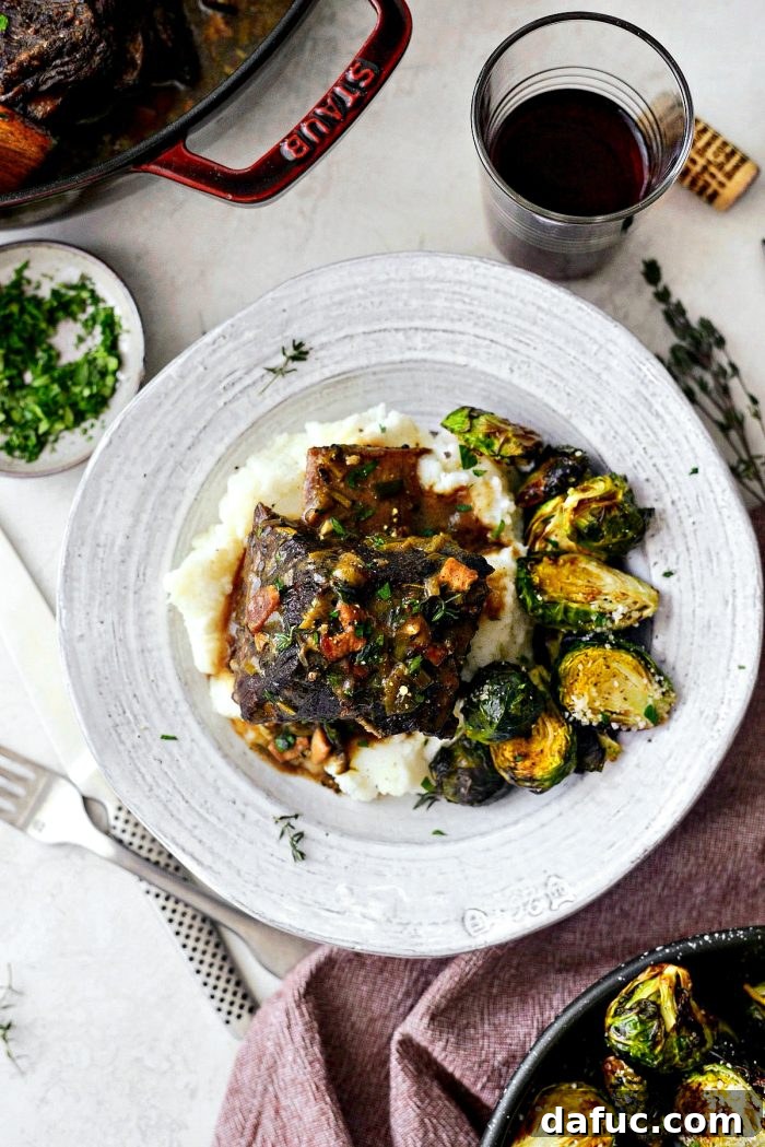 Slow-Braised Beef Short Ribs 21 The grand finale: Wine Braised Beef Short Ribs served on a bed of creamy mashed potatoes, generously drizzled with rich gravy and fresh parsley.