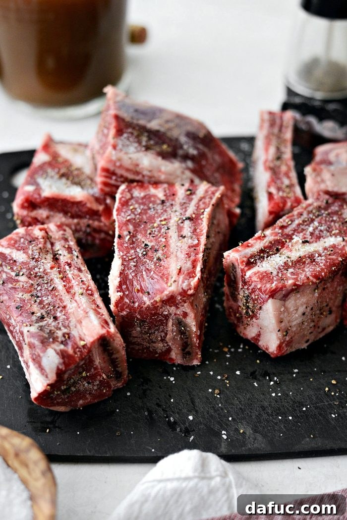 Slow-Braised Beef Short Ribs 6 Beef short ribs generously seasoned with kosher salt and freshly ground black pepper on all sides, ready for searing.