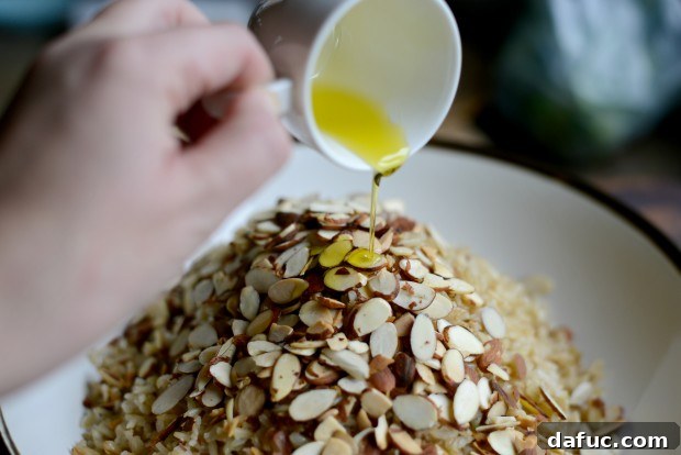 Fragrant Almond Basmati Pilaf 17 Pouring garlic-infused olive oil over rice and almonds