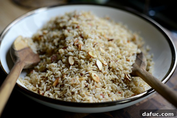 Fragrant Almond Basmati Pilaf 18 Tossing garlicky almond basmati rice in a serving bowl