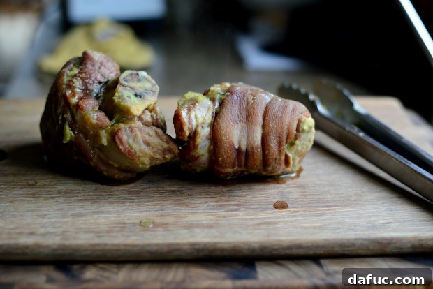 Removing ham hocks from the soup pot with tongs