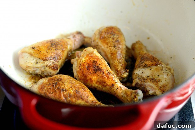 Slow-Simmered Chicken Stew 11 Chicken searing in hot bacon fat in a Dutch oven