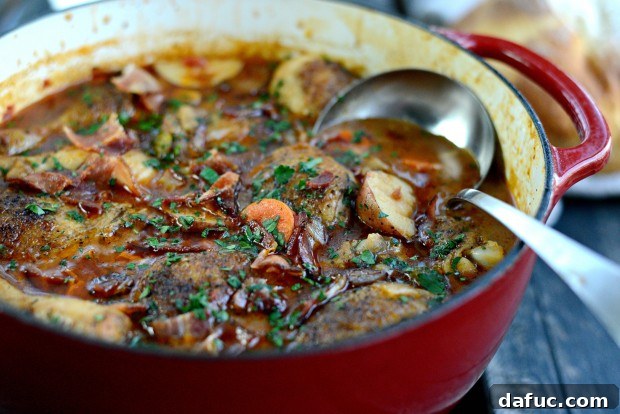 Slow-Simmered Chicken Stew 31 A wide shot of the served braised chicken stew with bread