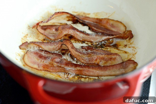 Slow-Simmered Chicken Stew 9 Bacon slices sizzling in a Dutch oven