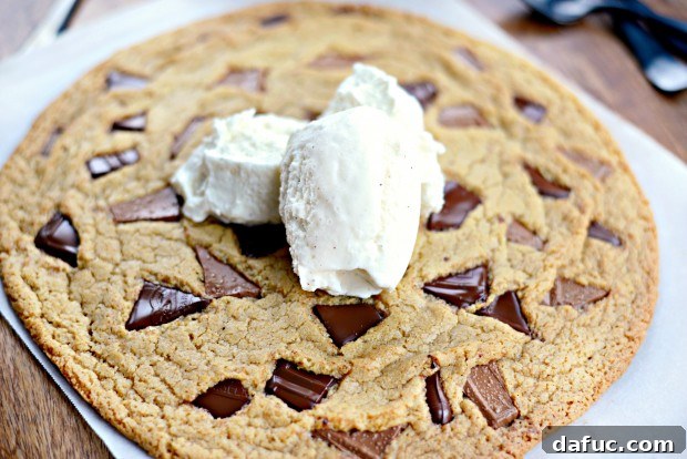 The large chocolate chunk cookie baking in the oven