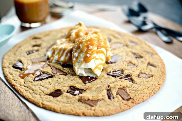 Warm double chocolate chunk cookie topped with scoops of vanilla ice cream