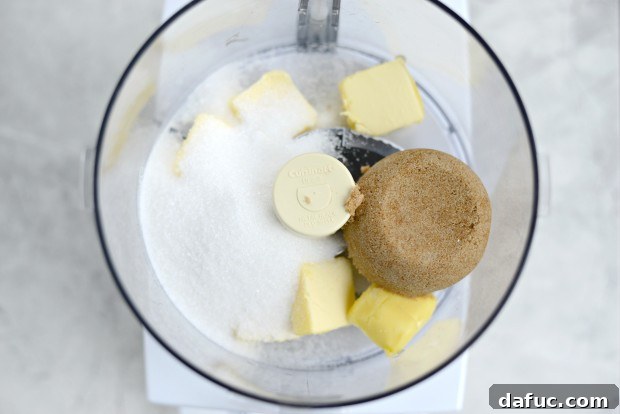 Unsalted butter in a food processor, ready for mixing