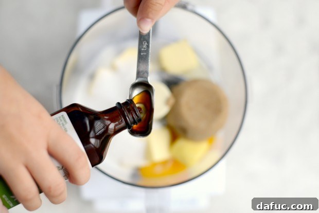 A large egg cracked into the food processor with butter and sugars