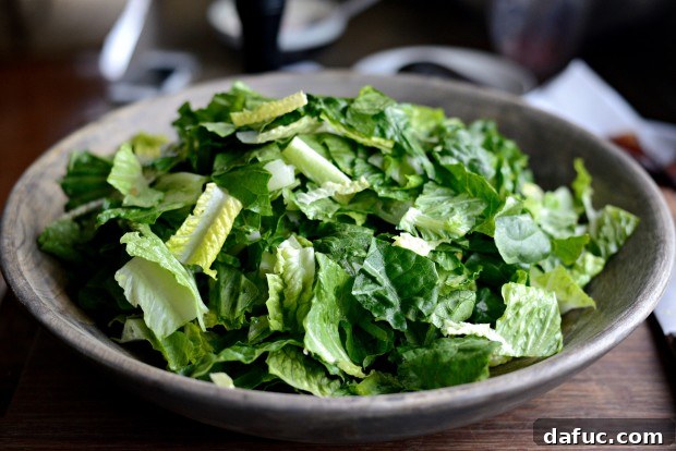 Chopped romaine lettuce in a large mixing bowl