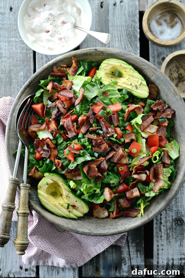 Overhead view of a vibrant BLAT salad with creamy dressing