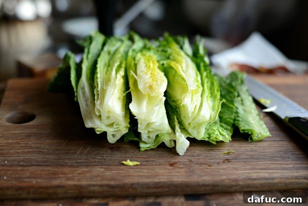 Trimming and cutting a head of romaine lettuce for salad