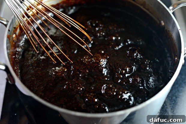 Adding corn syrup to chocolate mixture