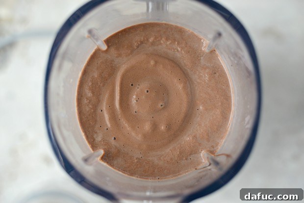 Chocolate Banana Bliss 12 Pressing the start button on a blender