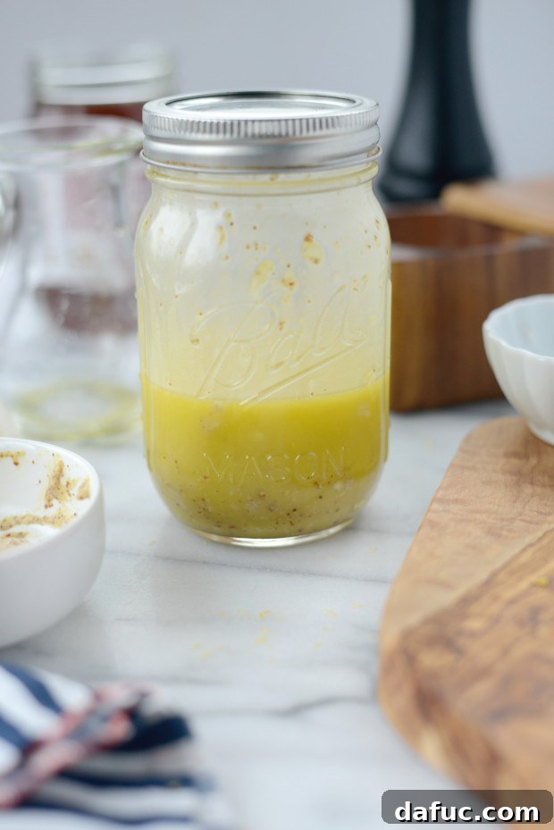 Securing the lid on a jar of lemon vinaigrette