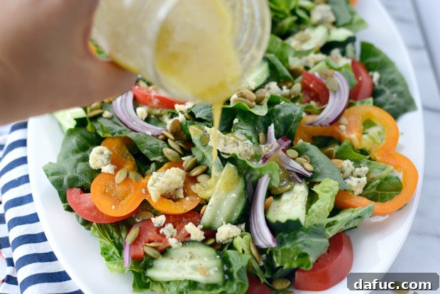 Shaking the jar to mix lemon vinaigrette