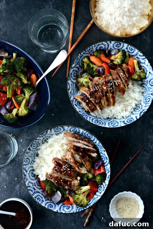 Sweet & Tangy Teriyaki Chicken Bowls 24 Finished teriyaki chicken rice bowl - garnished with sesame seeds and green onions