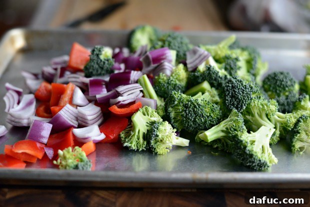 Sweet & Tangy Teriyaki Chicken Bowls 5 Vegetable prep - chopped broccoli, red onion, and bell pepper on a cutting board