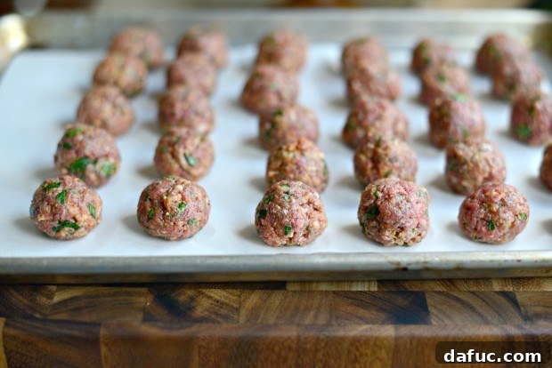 Meatballs on parchment-lined baking sheet