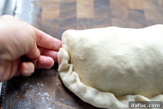 Transferring calzone to baking sheet