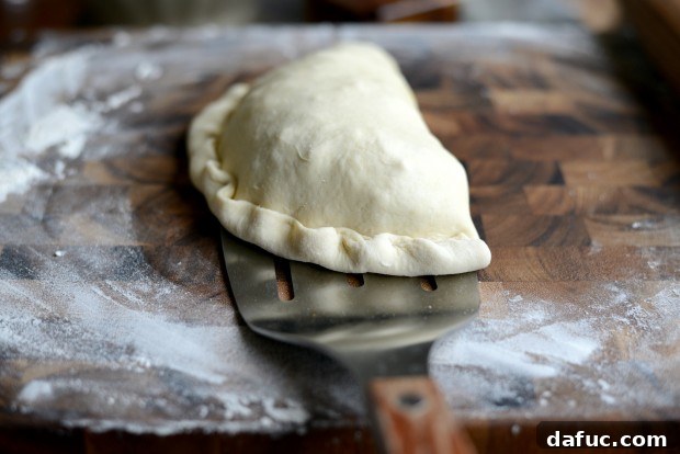 Brushing calzone with egg wash