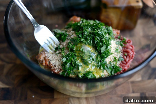 Adding beaten egg to meatball mix