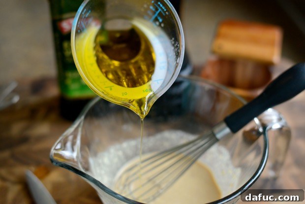 Fresh Kale Caesar with Light Caesar Dressing 15 Whisking dressing ingredients together in a bowl.