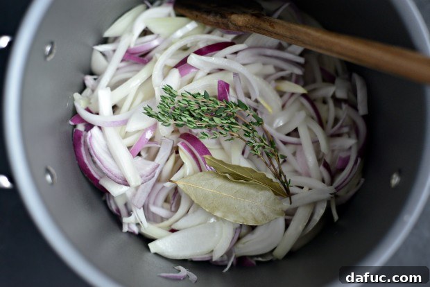 Fresh Thyme and Bay Leaves Added to Onions